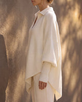 The Lorna Collared Knit in ivory — side profile on model showing the drape of the batwing sleeve