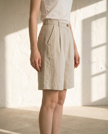 Linen-colour tailored shorts on model, side view – Moriel Heritage