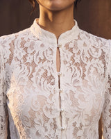 Florence Blouse in white — close-up of the floral lace, stand collar and pearl buttons