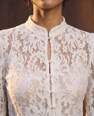 Florence Blouse in white — close-up of the floral lace, stand collar and pearl buttons