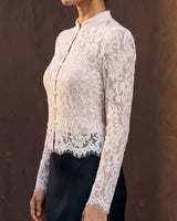 Florence Blouse in white — side view on model showing the fitted sleeve and scalloped hem