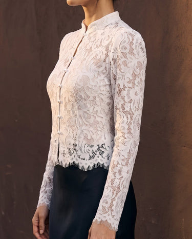 Florence Blouse in white — side view on model showing the fitted sleeve and scalloped hem
