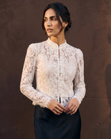 Florence Blouse in white — three-quarter front view on model against a warm backdrop