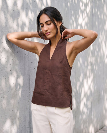 The Floriene Linen Blend Halter in coffee — halter top, front view with arms raised on model