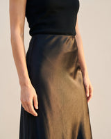 Close-up of black satin midi skirt showing the sheen and waistband – Moriel Heritage