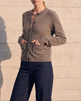 The Frankie Knit Cardi in khaki — angled view on model, hands in the patch pockets