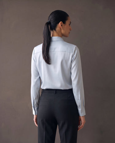 Back view of the light blue satin-look shirt showing the shoulder yoke