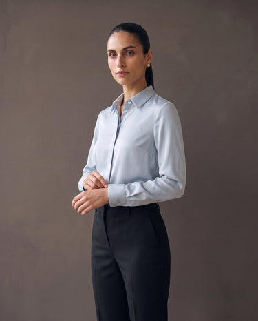 Model in the light blue satin-look shirt, three-quarter front view