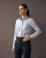 Full-length view of the light blue satin-look office shirt styled with black trousers