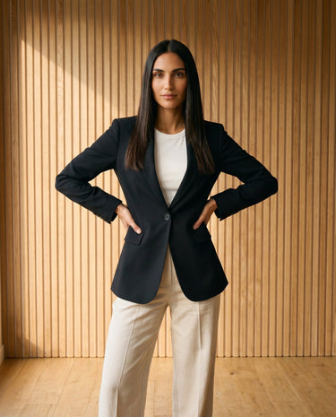 Graciela Cinch Waist Blazer in black — cinch-waist blazer styled over white top, front view on model