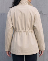 Back view of the light khaki Halden Coat showing the drawstring waist channel