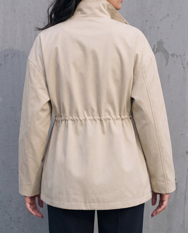 Back view of the light khaki Halden Coat showing the drawstring waist channel