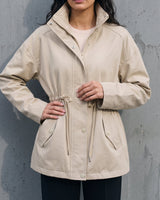 Model wearing the light khaki Halden Coat open, three-quarter front view