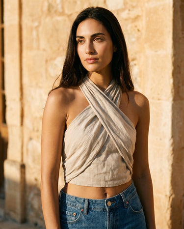 Beige linen halter crop top front view showing the wrapped neckline and cropped waist – Moriel Heritage