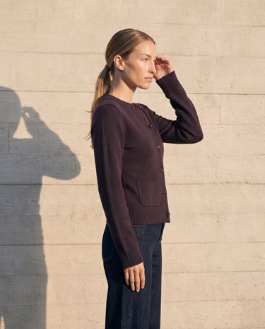 The Frankie Knit Cardi in aubergine — side profile on model showing the fitted waist