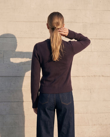 The Frankie Knit Cardi in aubergine — back view on model showing the seam-free back panel