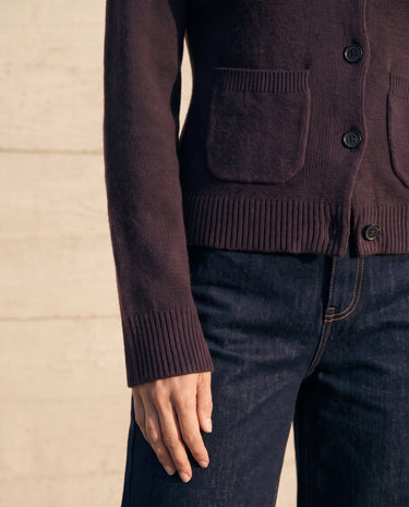 The Frankie Knit Cardi in aubergine — close-up of the patch pocket, ribbed hem and flared cuff