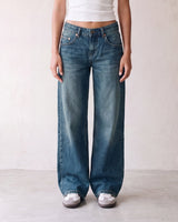 Harlow Low Rise Jeans in washed blue — low-rise baggy jeans styled with a white tank, front view on model