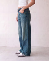 Harlow Low Rise Jeans in washed blue — side profile on model with hand in pocket