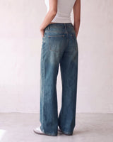 Harlow Low Rise Jeans in washed blue — back view on model showing the seat and patch pockets