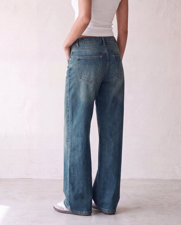 Harlow Low Rise Jeans in washed blue — back view on model showing the seat and patch pockets