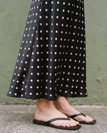 Hattie Polka Dot Skirt in black — close-up of the polka-dot print and flared hem