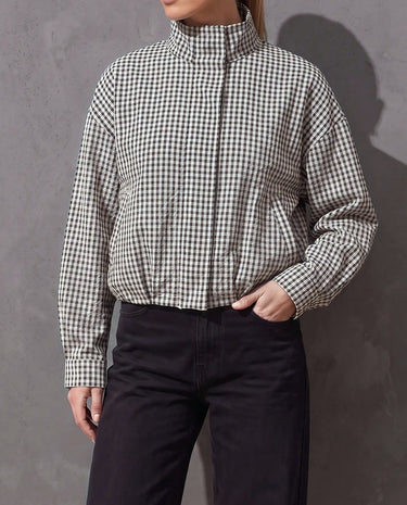 Henley Jacket in black and white gingham with stand collar, worn with black wide-leg jeans