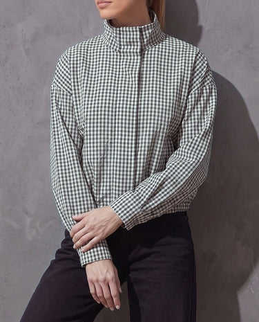 Henley Jacket styled casually, model leaning against a gray plaster wall