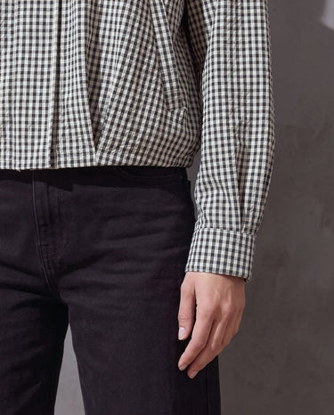 Close-up of the Henley Jacket pleated front hem and cuff