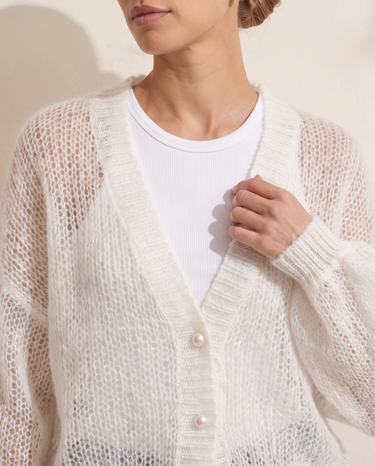Marisol Knit Cardigan in White, close-up of the V neck ribbed placket and pearl buttons