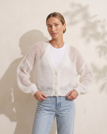 Marisol Knit Cardigan in White, model with hands at the ribbed hem