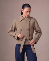 Lorelai Trench Coat in brown check — three-quarter view showing the boxy cropped shape and belted cuffs