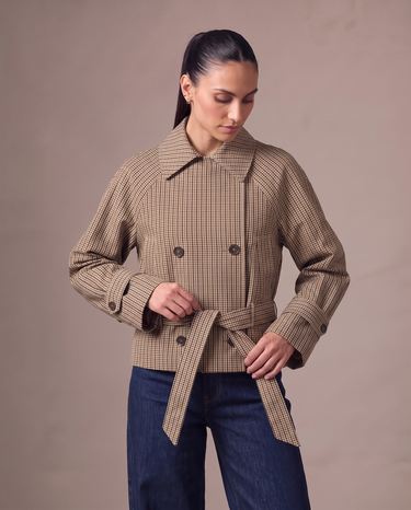 Lorelai Trench Coat in brown check — three-quarter view showing the boxy cropped shape and belted cuffs