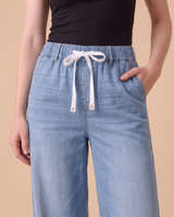 Close-up of the Isla jeans drawstring waistband with X-stitched tips
