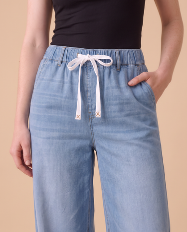 Close-up of the Isla jeans drawstring waistband with X-stitched tips