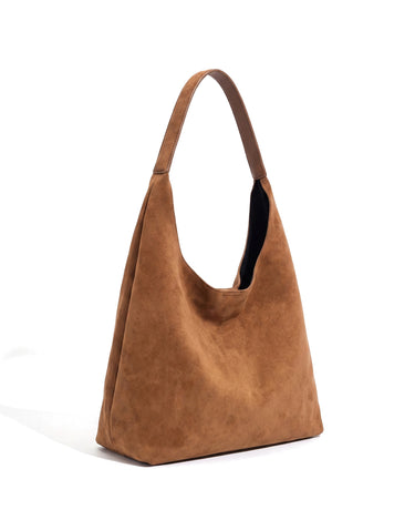 The Léa Slouch Tote in brown suede, studio hero view showing the soft slouched silhouette