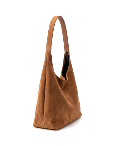 The Léa Slouch Tote in brown suede, side profile view showing the angled base