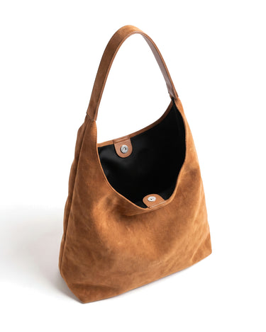 The Léa Slouch Tote in brown suede, open top view showing the black lining and press-stud closure