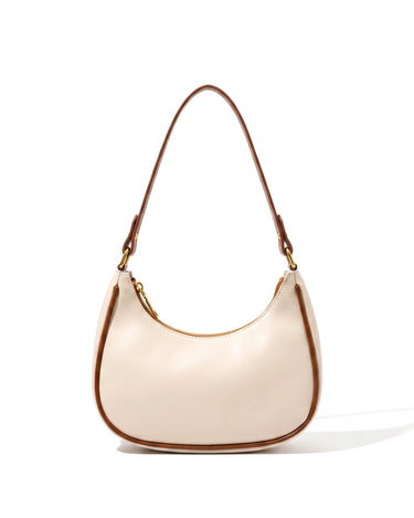 The Ines Crescent Bag in cream with tan trim, front view on a pure white studio background