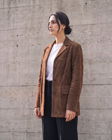 Model in the dark brown Isla Faux Suede Jacket, three-quarter front view showing the longline hip-length cut