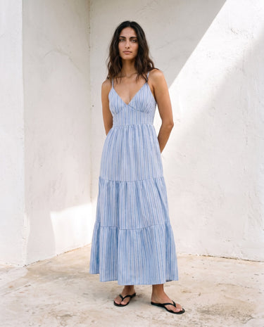 Isla Striped Summer Maxi Dress in blue stripe — sleeveless V-neck tiered maxi dress, front view on model