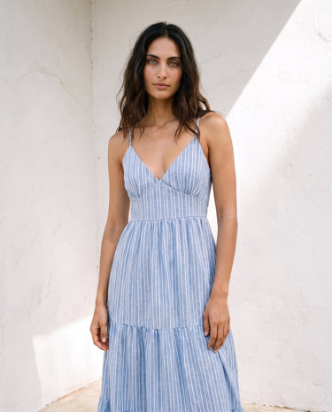 Isla Striped Summer Maxi Dress in blue stripe — strappy V-neck maxi dress, three-quarter view on model