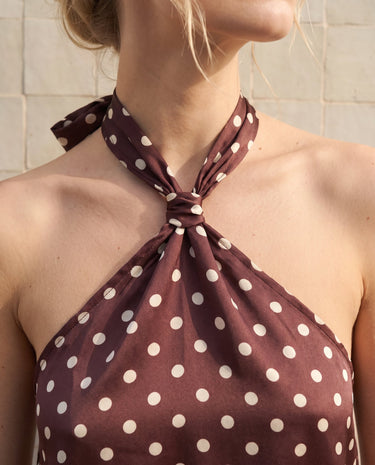 Isola Halter Neck in brown polka dot — close-up of the knotted halter neckline