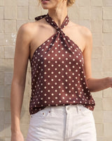 Isola Halter Neck in brown polka dot — three-quarter front view showing the relaxed swing body