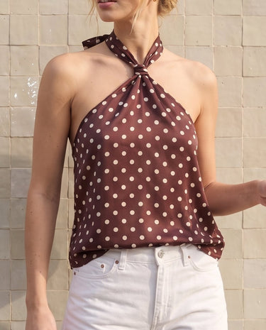 Isola Halter Neck in brown polka dot — three-quarter front view showing the relaxed swing body