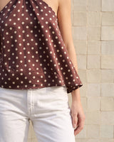 Isola Halter Neck in brown polka dot — side view showing the fluid drape of the body