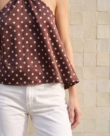 Isola Halter Neck in brown polka dot — side view showing the fluid drape of the body