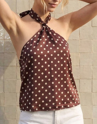 Isola Halter Neck in brown polka dot — front view on model with arm raised