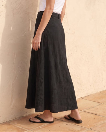 Kyra Flow A Line Skirt in black — flowing A-line maxi skirt, side view on model