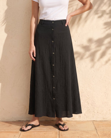 Kyra Flow A Line Skirt in black — button-front A-line maxi skirt, front styling view on model
